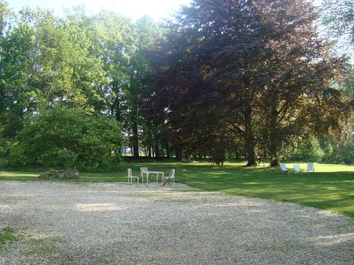 a group of tables and chairs in a park at Chalet Du Bel Event in La Chapelle-sur-Dun