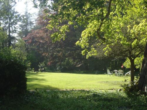 a park with tables and chairs in the grass at Chalet Du Bel Event in La Chapelle-sur-Dun