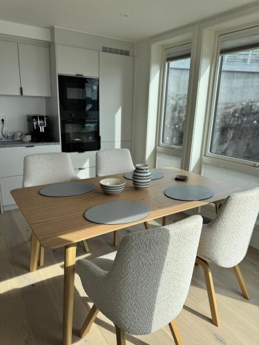 a wooden table and chairs in a kitchen at NORDIQ by the Fjord in Lii