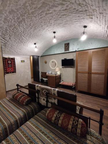 a hotel room with a bed and a television at Wine Story Hotel in Tbilisi City