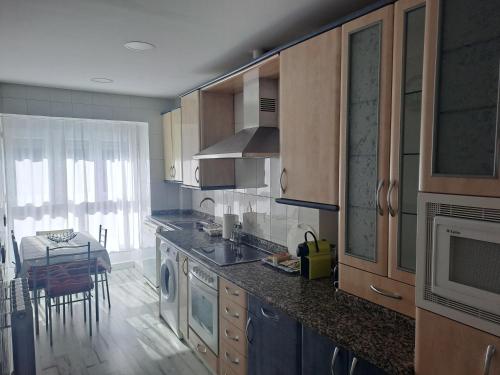 A kitchen or kitchenette at Apartamentos El Conde