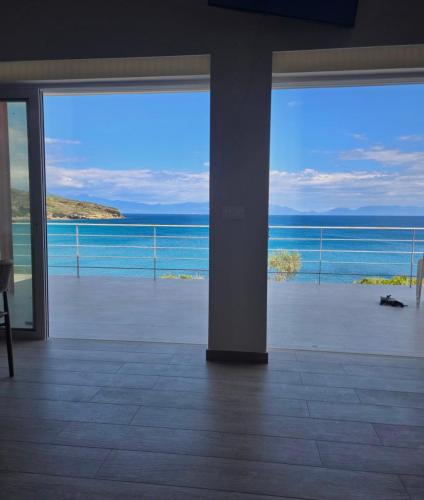 a view of the ocean from a room with sliding glass doors at Thalasson Beach House in Koroni