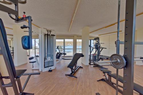 a gym with treadmills and machines in a room at Palmariva Beach Hotel in Eretria