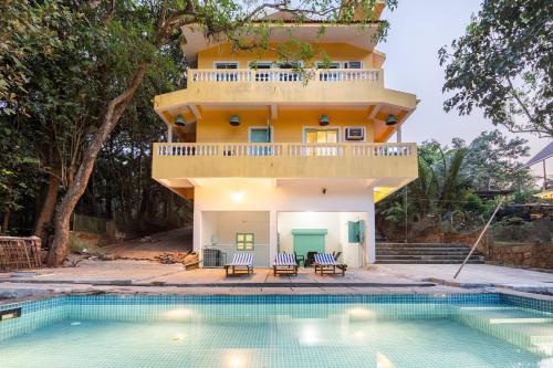 a house with a pool in front of it at Independent Villa with private pool in Siolim Goa in Oxel