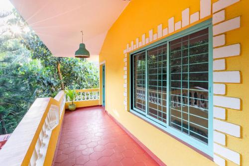 a balcony with a bench and a window at Independent Villa with private pool in Siolim Goa in Oxel
