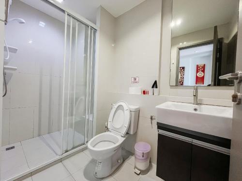 a bathroom with a toilet and a sink and a shower at The base central Pattay CD in Pattaya Central