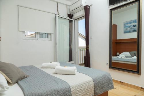 a bedroom with a bed and a large mirror at Vila Midami - Herceg Novi Savina in Herceg-Novi