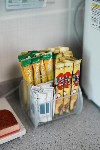 a container of food sitting on a counter next to a refrigerator at Mungyeong YeoU in Mungyeong