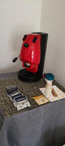 a red coffee maker sitting on top of a table at Affittacamere GG in Preganziol