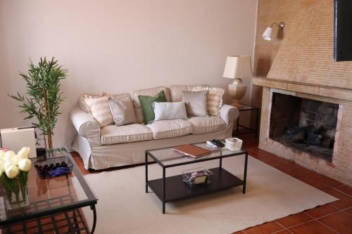 a living room with a couch and a fireplace at Terras da Planície in Ferreira do Alentejo