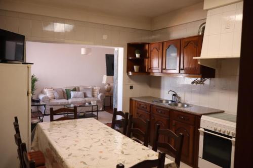 a kitchen with a sink and a table in a kitchen at Terras da Planície in Ferreira do Alentejo