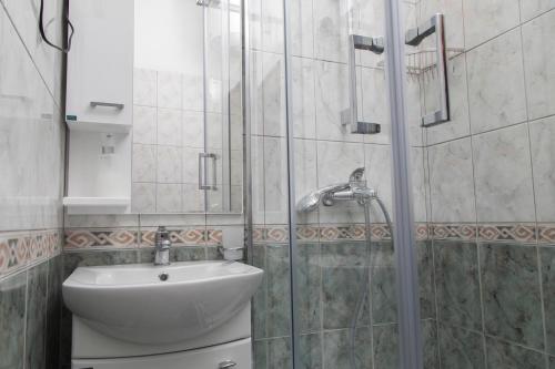a bathroom with a sink and a glass shower at Vila Midami - Herceg Novi Savina in Herceg-Novi