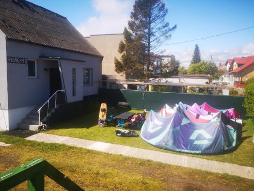 a group of tents in a yard next to a house at Apartamenty Mewa in Rewa
