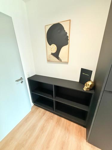 a room with black drawers and a painting on the wall at MIWO Friedrichshafen in FDH
