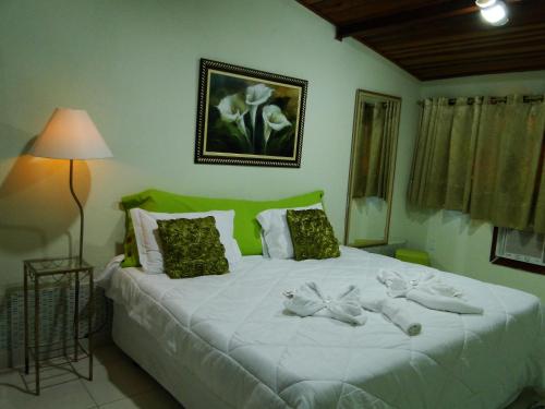 Giường trong phòng chung tại Pousada das Acerolas