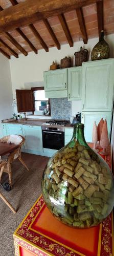 a kitchen with a large vase sitting on a table at PassionToscane in San Giovanni dʼAsso