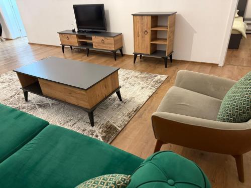 a living room with a couch and a coffee table at Riga's Apartment in Prizren