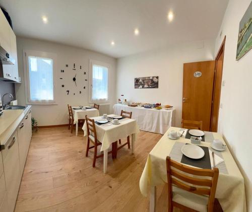 a kitchen and dining room with tables and chairs at B&B Villa Griselda in Quinto di Treviso