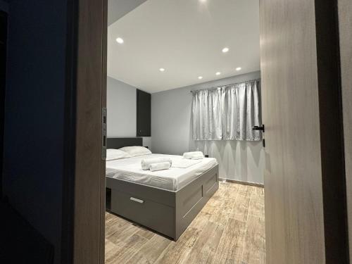 a bedroom with a bed and a window at Magic View Luxury Villa 4u - Spiro Spero in Kineta
