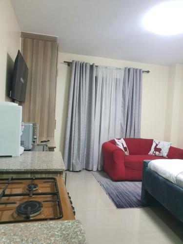 a living room with a couch and a red couch at Stade View Suits RH 4002 in Nairobi