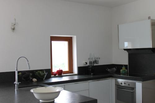 a kitchen with a sink and a bowl on a counter at Collina Di Sopra in Tresana