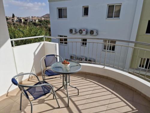 a balcony with a table and chairs on a balcony at Oceania Bay Village in Pyla