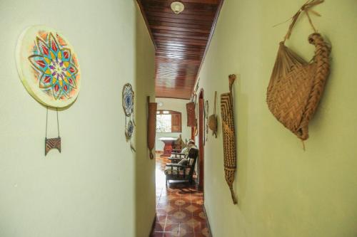 a hallway with various items on the walls of a house at Hostel Roraima in Boa Vista