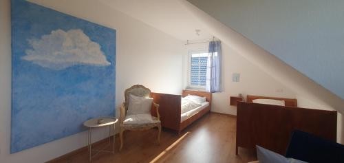 a bedroom with a bed and a painting of a cloud at Ferienwohnung Luft und Erde in Celle