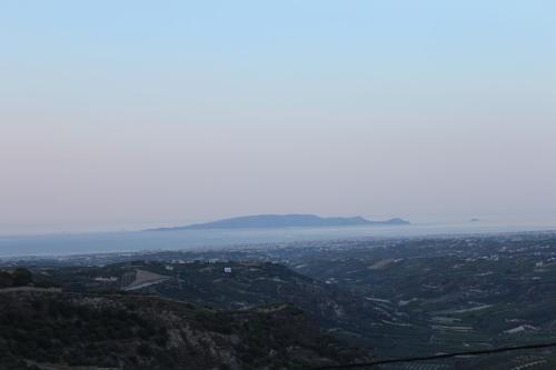 a view of the ocean from the top of a mountain at Myron Luxury Living in Agios Myronas