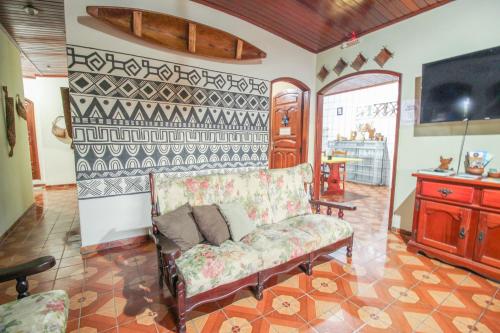 a living room with a couch and a tv at Hostel Roraima in Boa Vista