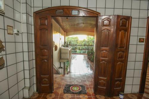 an entrance to a kitchen with a wooden door at Hostel Roraima in Boa Vista