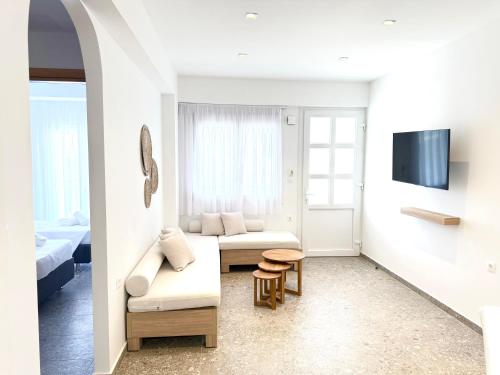 a living room with a couch and a table at Sakellis Home 2- Steps to Beach & Town in Kardamaina