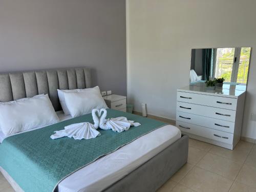 a bedroom with a bed with towels on it at City View Apartments in Lezhë