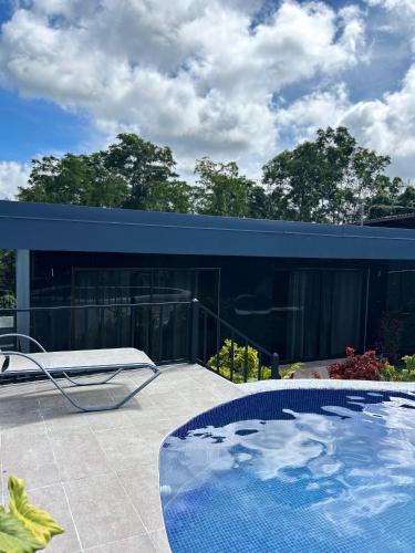 a house with a swimming pool on a patio at Residencia Esmeralda in Agua Buena
