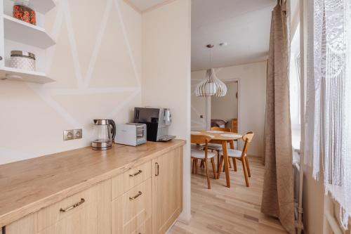 a kitchen with a wooden counter top and a table at Kuuse 4 Apartment in Haapsalu