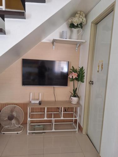 a living room with a flat screen tv on a wall at More than Space Staycation in Sampong