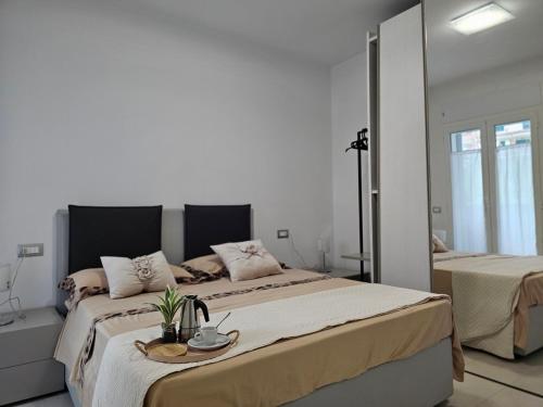 a bedroom with two beds with a tray on it at Grey House1 100m to the beach in Tortoreto Lido