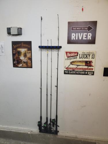 a white wall with signs and ski poles on it at Tony's Riverside Oasis in Sultan