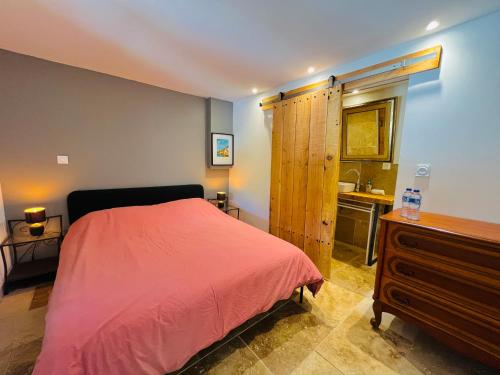 a bedroom with a bed and a sink in it at PierrAnge in Grillon
