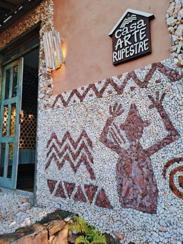 a building with a mosaic art on the side of it at Casa Arte Rupestre in Ibicoara