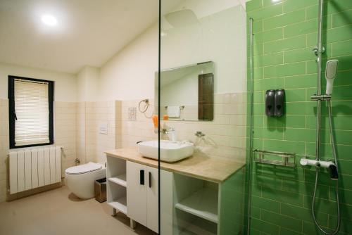 a bathroom with a sink and a glass shower at Boutique Hotel Kviria in Tʼelavi
