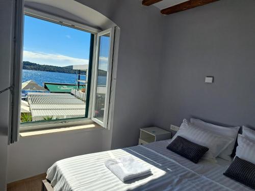 a bedroom with a bed and a large window at La Vie Seaside Residences in Šibenik