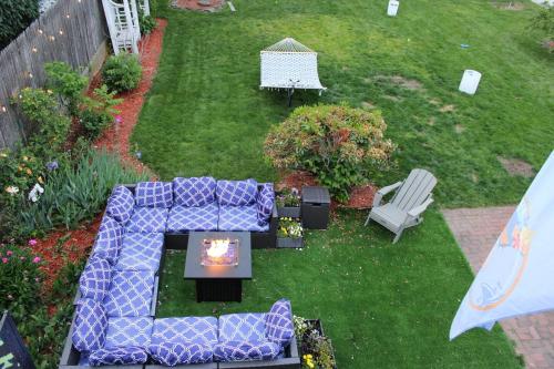 an aerial view of a garden with a couch and chairs at NEW! Family-Friendly Getaway -1 Mi to Dtwn Salem w Roof Deck & Tiki Bar in Salem