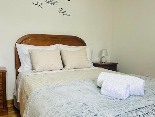 a bedroom with a large bed with white pillows at Sweet Home in Miranda do Douro