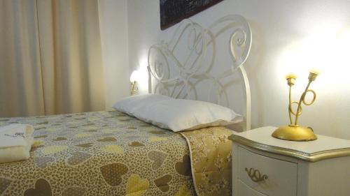 a bedroom with a bed and a table with a lamp at Dodo House in Nocera Inferiore