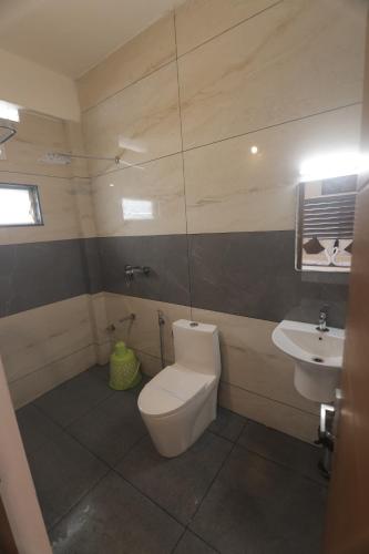 a bathroom with a toilet and a sink at Himasailam Pool Resort Vagamon in Vagamon