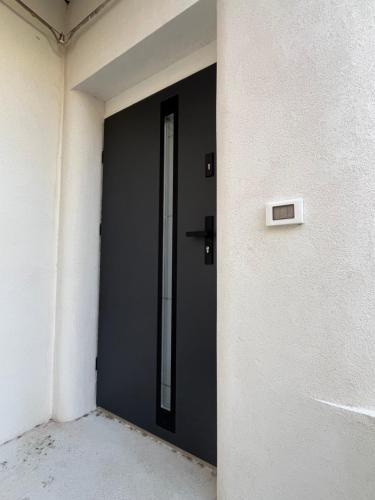 a black door on the side of a building at La Terrazza in centro in Marsala