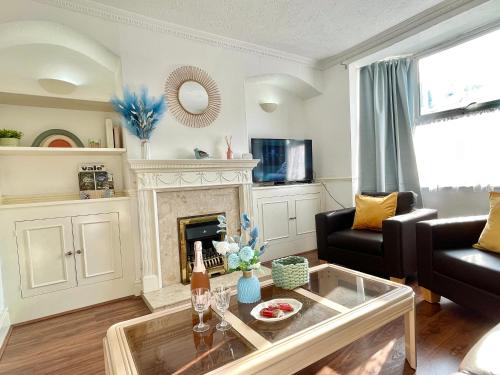 a living room with a couch and a fireplace at Lavender Dream House in Evesham