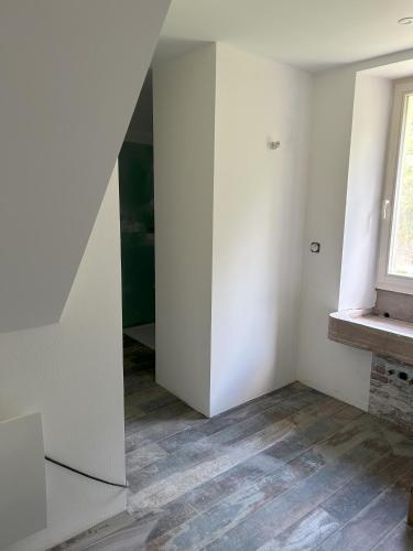 a room with white walls and a window at Senones Jardin de la princesse in Senones