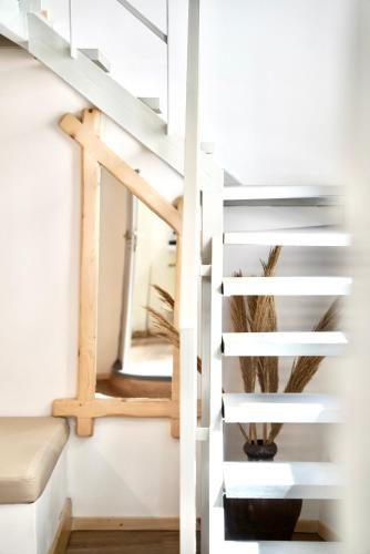 a staircase in a house with a mirror at Èar in Ermoupoli